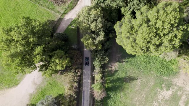 Classic green convertible car driving along rural roads in the south of France, Aerial looking down shot