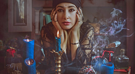 Concept of fortune telling and predictions of fate, magic and wicca elements on a table, witch look - obrazy, fototapety, plakaty