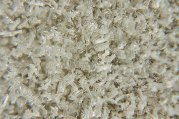 Snowflakes on the glass are golden silvery.