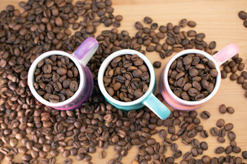 Coffee beans in cute and colorful small espresso cups