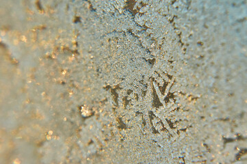 Snowflakes on the glass are golden silvery.