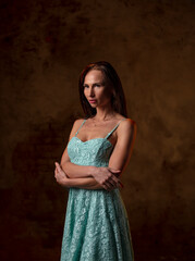 portrait of a beautiful young woman in a photo studio on a dark background