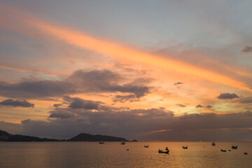 aerial view beautiful sunset at Kalim beach. stunning cloud in sky of sunset..Kalim beach is conect to Patong beach there have a lot of reef and rocks