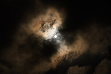 Fototapeta na wymiar Bright sun in sky with dark clouds.