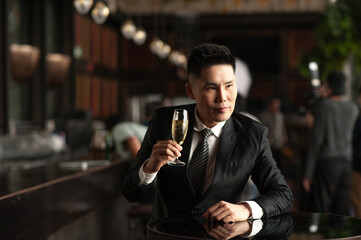 Asian business man holding champagne celebrate success