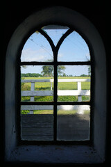 The view from a window of an old mill. It has an arch and glass panels. Location:  Neuharlingersiel, East Friesland, Germany