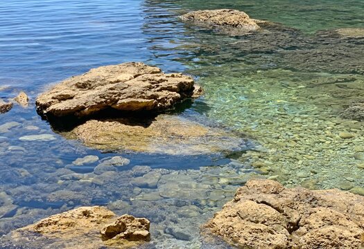 Sea transparent clear water. Stones and pebbles on ocean floor.