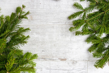 Christmas composition. Christmas tree decorations, fir tree branches on white wooden background. Flat lay, top view, copy space