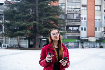 smiling girl with glasses on a snowy day