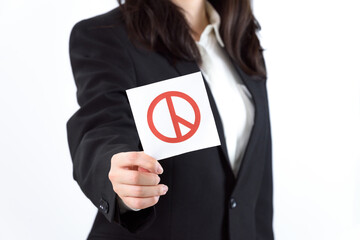 A Korean woman wearing a suit and holding a ballot.