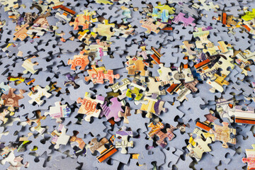 Background of scattered colorful puzzle pieces. A bunch of jigsaw puzzle pieces.