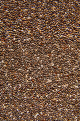 Flat lay macro natural dried Chia seeds, top view, close up texture background