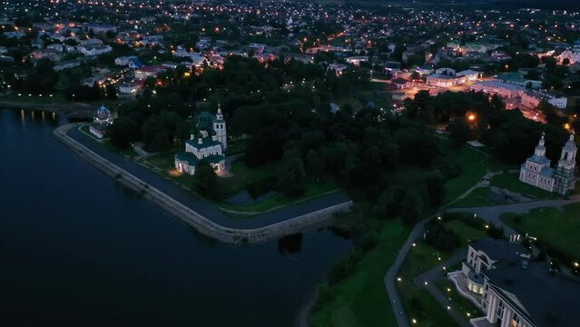 Flight over evening city of Uglich and Epiphany Cathedral on the banks of Volga River
