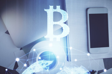 Double exposure of blockchain theme hologram over table with phone. Top view. Crypto technology...