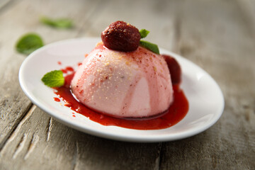 Homemade strawberry panna cotta with berry sauce