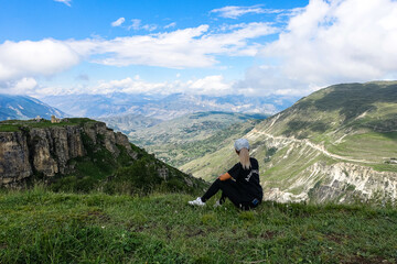 A girl on the background of a view of the Matlas plateau. Khunzakhsky district. Dagestan Russia 2021