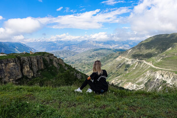 A girl on the background of a view of the Matlas plateau. Khunzakhsky district. Dagestan Russia 2021