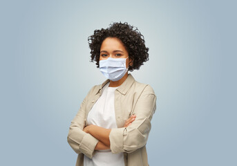 health, pandemic and quarantine concept - woman wearing face protective medical mask for protection...