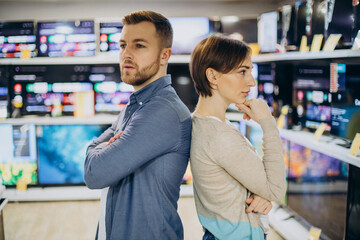 Couple choosing television at store