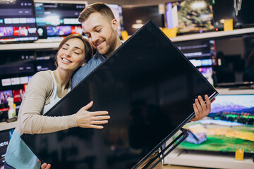 Couple buying television at store