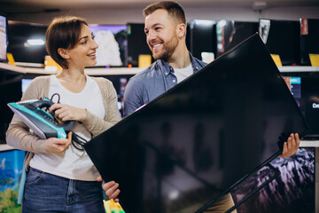 Couple buying television at store