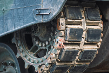 Fototapeta na wymiar Armored crawler tank. Dirty and rusty tank tracks, close up