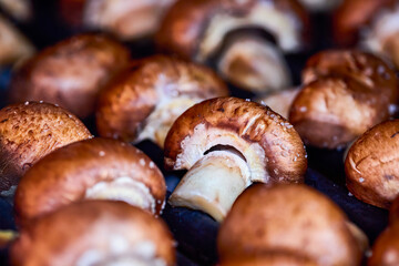 close up with brown champignon mushrooms on the grill.