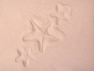 Fototapeta na wymiar Starfish trace on a sand surface. Summerbackground good for Seasonal Sale or Tour Trip announce.