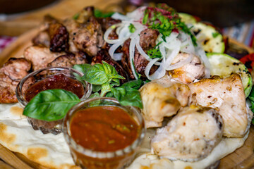 The richly laid table dishes of Georgian cuisine, lots of delicious food,wine,fruits and roasted meat
