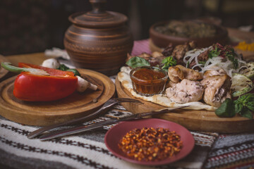 The richly laid table dishes of Georgian cuisine, lots of delicious food,wine,fruits and roasted meat