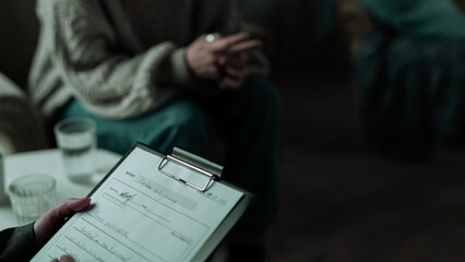 Close Up Photo of a Psychiatrist Sitting With a Depressed White Girl in a Modern Industrial...