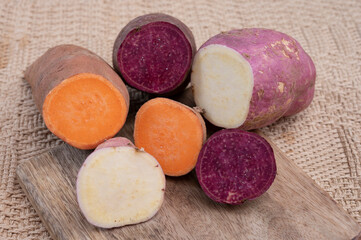 Obraz na płótnie Canvas Colorful root vegetables pink, purple and orange organic sweet potatos