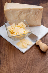 Flakes of parmesan cheese, italian hard parmigiano-reggiano cheese from Reggio Emilia region