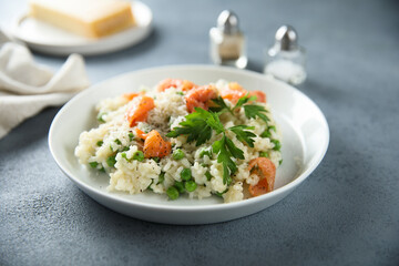 Homemade risotto with salmon and green pea
