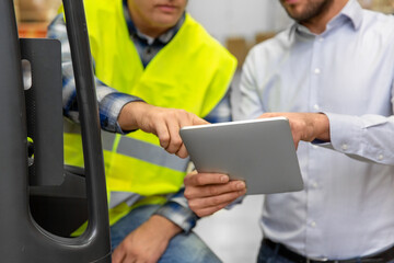 wholesale, logistic, loading, shipment and people concept - close up of loader on forklift and...