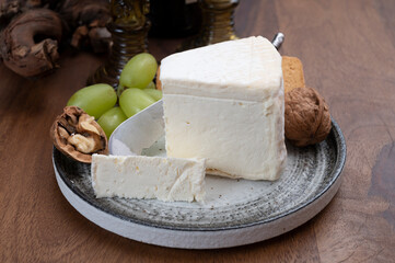 Delice de Bourgogne French cow's milk cheese from Burgundy region of France served with grapes, wine and walnuts