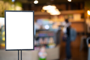 mockup white poster with black frame stand in front of blur restaurant cafe background