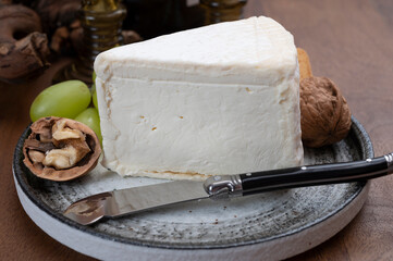Delice de Bourgogne French cow's milk cheese from Burgundy region of France served with grapes, wine and walnuts