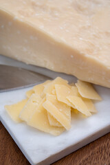 Flakes of parmesan cheese, italian hard parmigiano-reggiano cheese from Reggio Emilia region