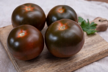 Fototapeta na wymiar Healthy vegetarian food, reddish brown sweet kumato tomatoes
