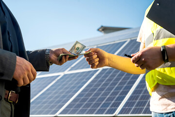foreman receives a salary from a businessman after work on the installation of solar panels