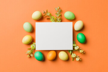Naklejka na ściany i meble round frame multicolored Easter eggs with white blank paper on a brown background, close-up, space for text, blank for design, selective focus, tinted image