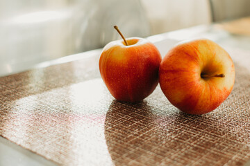 Two fresh red apples on the table close-up