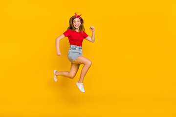 Full size photo of impressed teen girl run wear t-shirt hairband skirt footwear isolated on yellow background