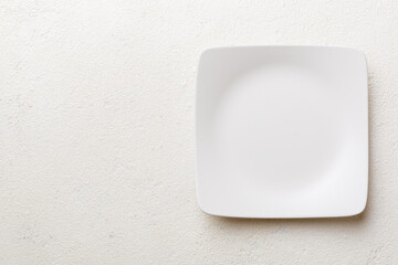 Top view of empty square plate on cement background. Empty space for your design