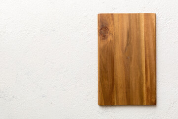 Top view of wooden cutting board on cement background. Empty space for your design