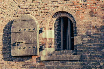Wall with window and bars from Fortrtess Buitensluis in Numansdorp The Netherlands.