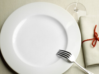 empty white plate on the table with tablecloth