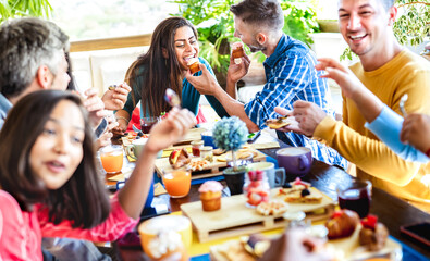 Happy friends eating and drinking at coffee bar garden - Young people having fun together at...