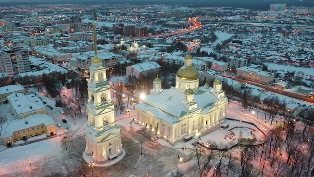 Scenic aerial view of snow covered cityscape of Penza overlooking restored architectural complex of Spassky Cathedral in winter evening, Russia